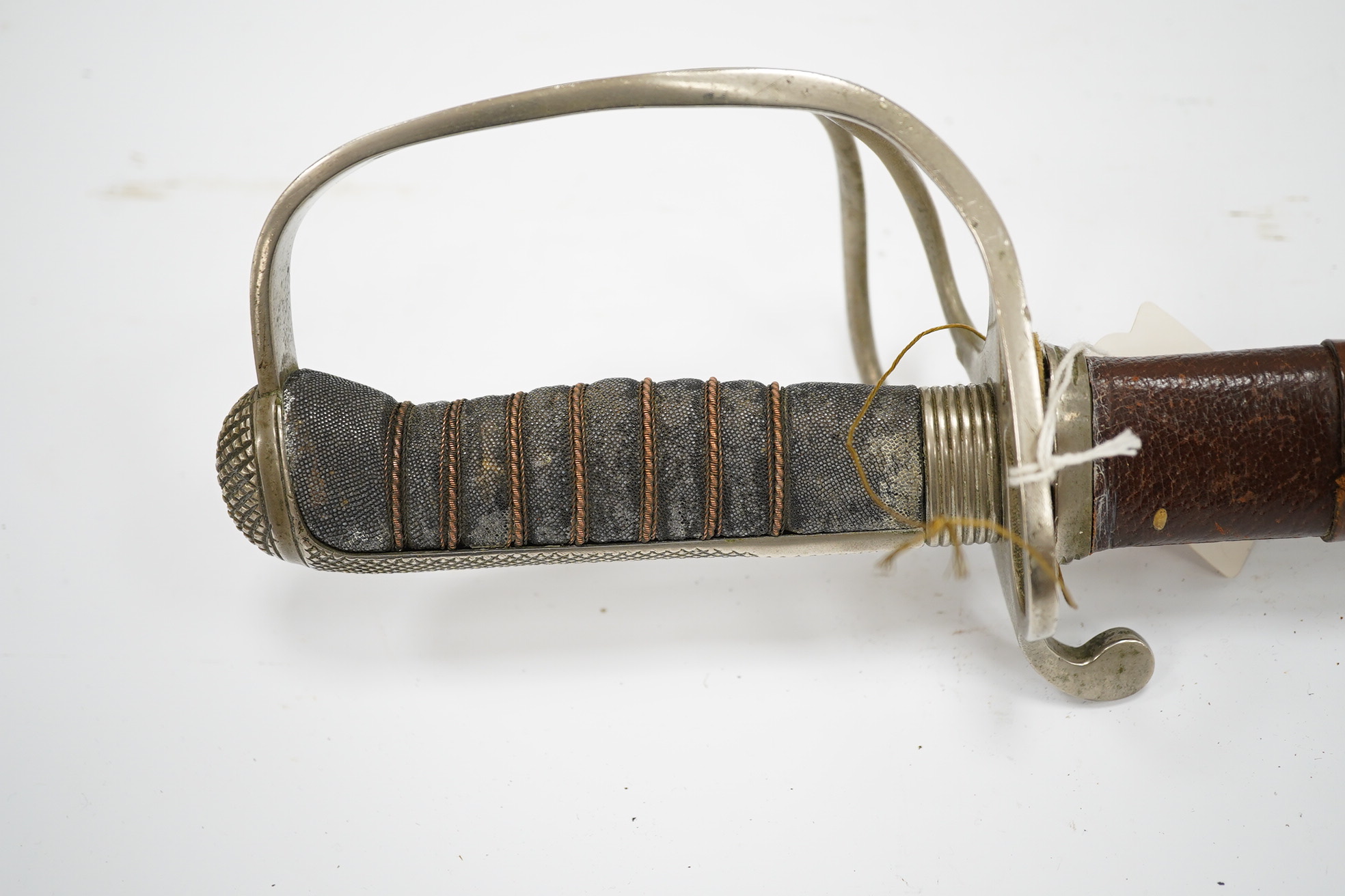 An 1821 pattern GVIR light cavalry officer’s sword in its leather scabbard, Royal Army Service Corps, blade etched with owners initials; JNDA and also with initials RASC, with regulation nickel guard, in its leather fiel